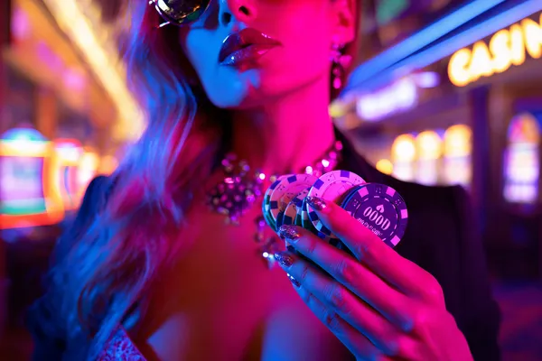 A confident dealer surrounded by casino chips inviting players to access their RAJ123 account, reflecting quick and easy login options.